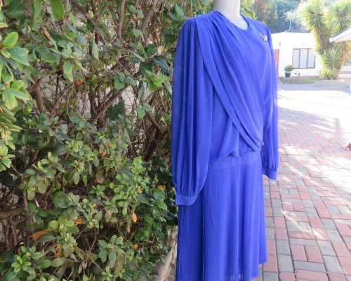 Elegant special occasion royal blue sheer fully lined size 38/14 dress by HELENEL.Pleated bottom.