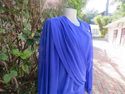 Elegant special occasion royal blue sheer fully lined size 38/14 dress by HELENEL.Pleated bottom.