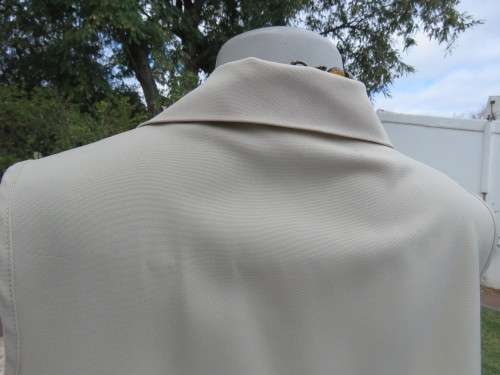 As new sleeveless cream top closing with 2 buttons and open collar. By SMILEY`S size 40/16.