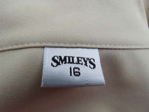 As new sleeveless cream top closing with 2 buttons and open collar. By SMILEY`S size 40/16.