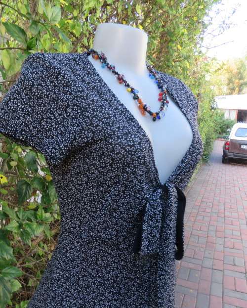 Feather light monochrome 100% stretch nylon low V dress. FINNIGANS size 38/14.Capped sleeves.As new