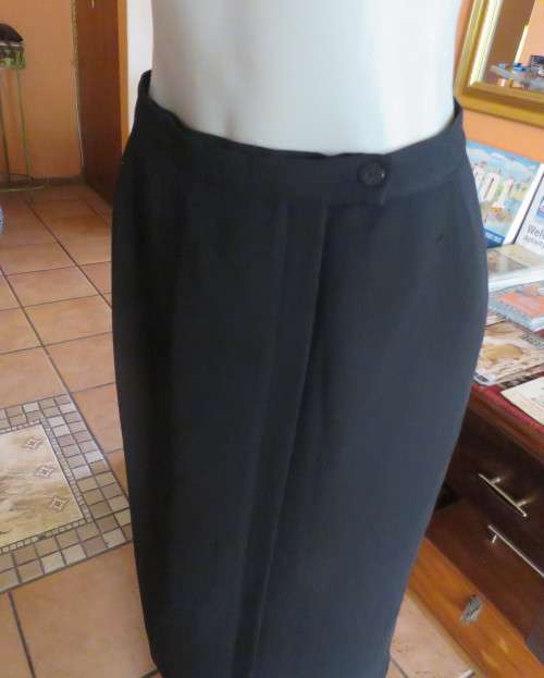 Top of the line black cross over fully lined honeycomb polyester size 38 skirt by WOOLWORTHS.As new