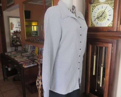 Practical black and white check long sleeve shirt. Button down with open collar. Size 34/10.As new