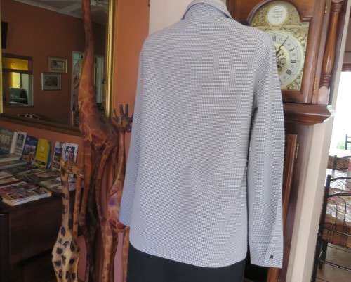 Practical black and white check long sleeve shirt. Button down with open collar. Size 34/10.As new