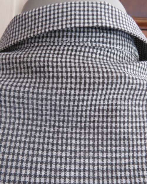 Practical black and white check long sleeve shirt. Button down with open collar. Size 34/10.As new