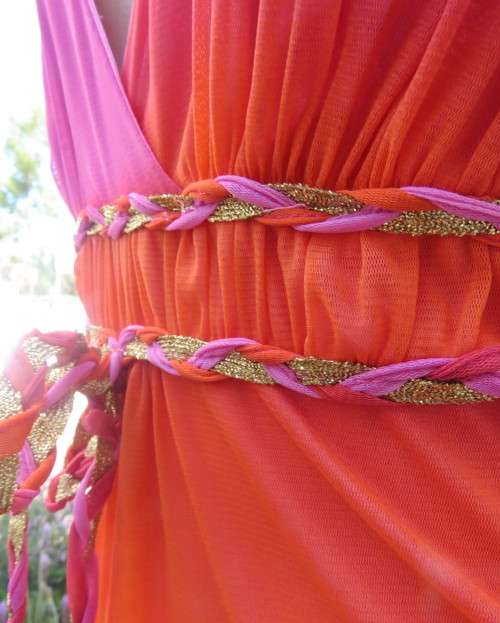 Super sexy cross over top in sheer pink/crimson fabric.Braiding with gold in waist.Size 36.By OASIS.