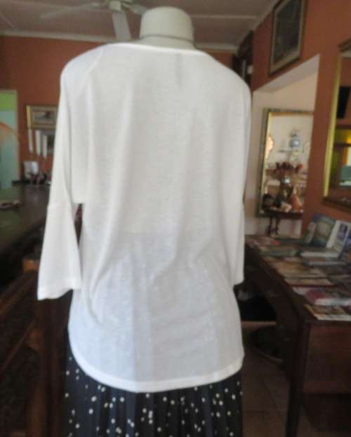 Light as a feather soft white slip over top in poly/viscose.Dolman sleeves.Size 38/14 by WOOLWORTHS.