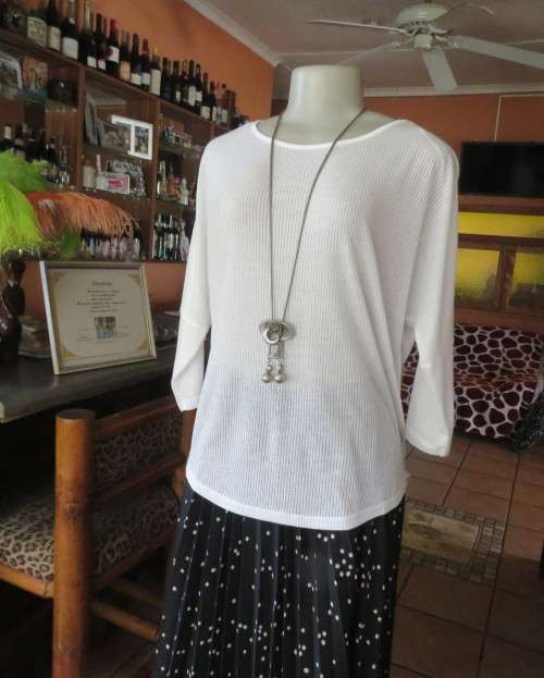 Light as a feather soft white slip over top in poly/viscose.Dolman sleeves.Size 38/14 by WOOLWORTHS.