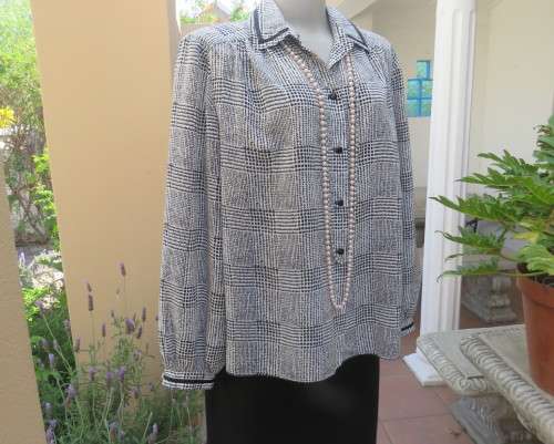 Make a statement in this black/white check long sleeve button down boutique made size 44/20 blouse.
