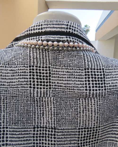 Make a statement in this black/white check long sleeve button down boutique made size 44/20 blouse.
