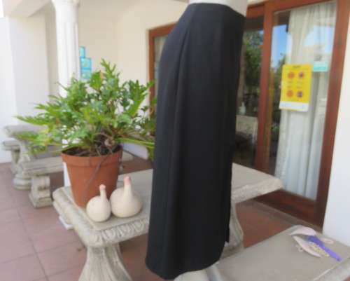 Elegant ankle length black pencil skirt. Slit at left side and button decoration in waist.Size 36