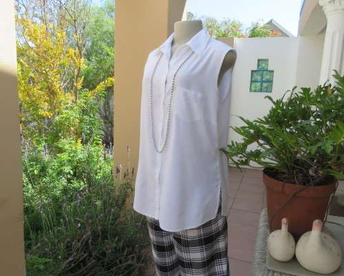 Snow white sleeveless summer top.Button down with shirt collar.By WOOLWORTHS size 38/14.As new.