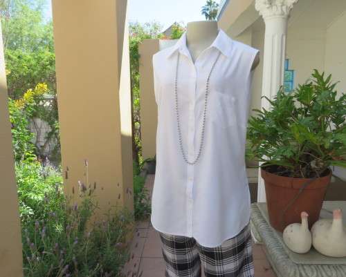 Snow white sleeveless summer top.Button down with shirt collar.By WOOLWORTHS size 38/14.As new.