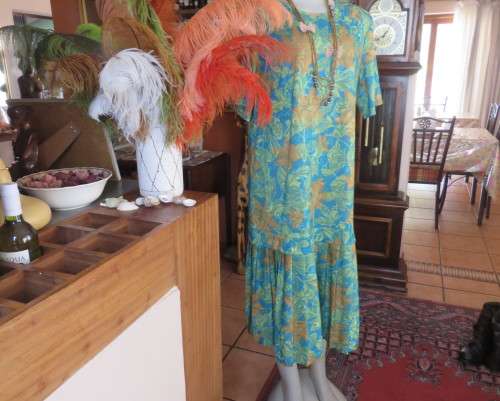 As new vintage dropped waist dress in cool greens and turquoise.Size 44/20 b PRODUCTION STREET.