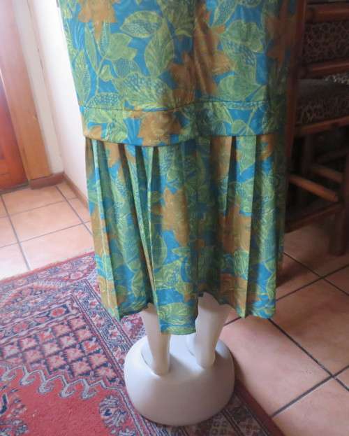 As new vintage dropped waist dress in cool greens and turquoise.Size 44/20 b PRODUCTION STREET.
