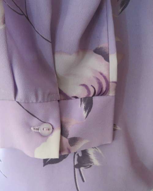 Lavender long sleeve blouse with button down front. Bold purple/white flowers.Size 42 by AREZZO.