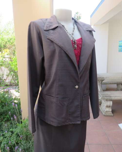 Light weight 2 pc smoke grey skirt suite.Long sleeve 1 button jacket/bandless skirt size 38.As new.