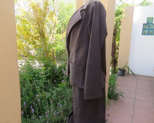 Light weight 2 pc smoke grey skirt suite.Long sleeve 1 button jacket/bandless skirt size 38.As new.