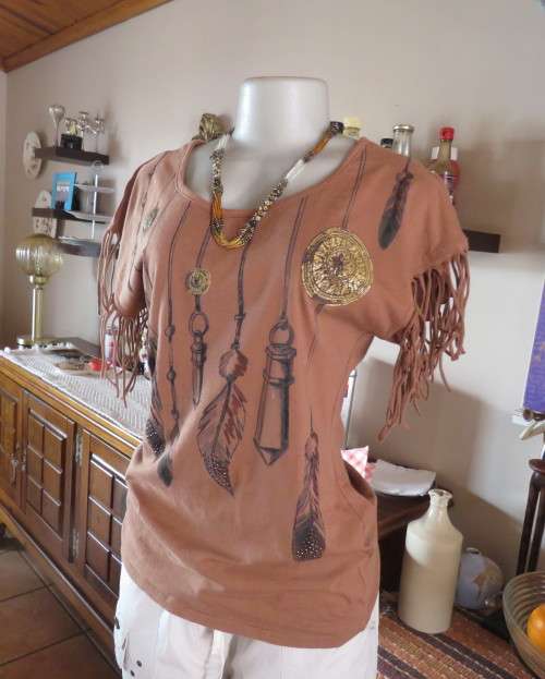 Unique golden brown LEGIT size 34/10 slip over top.Fringed armholes.Front feather/gold patterned.
