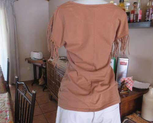 Unique golden brown LEGIT size 34/10 slip over top.Fringed armholes.Front feather/gold patterned.