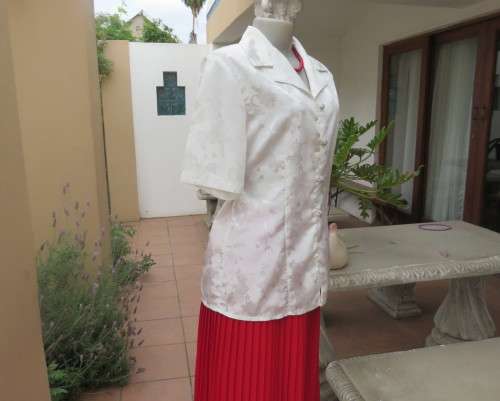 Shiny light cream tailored polyester satin short sleeve top with embossed patterns.Size 38/14.As new