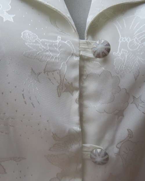 Shiny light cream tailored polyester satin short sleeve top with embossed patterns.Size 38/14.As new
