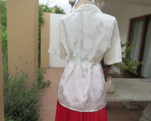 Shiny light cream tailored polyester satin short sleeve top with embossed patterns.Size 38/14.As new