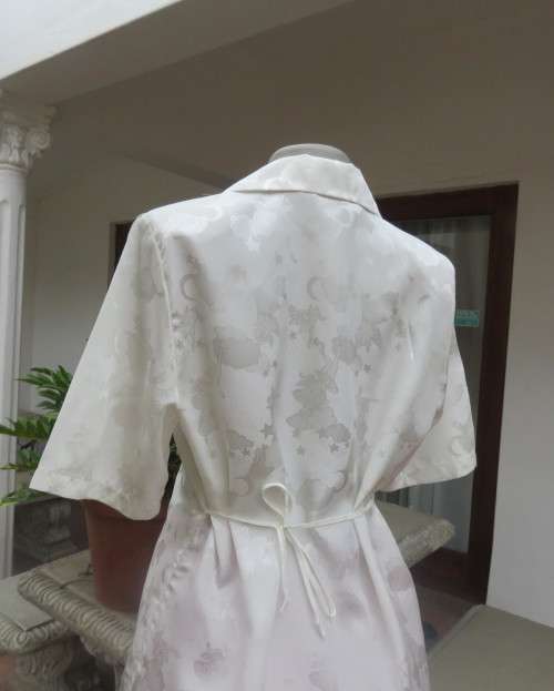 Shiny light cream tailored polyester satin short sleeve top with embossed patterns.Size 38/14.As new