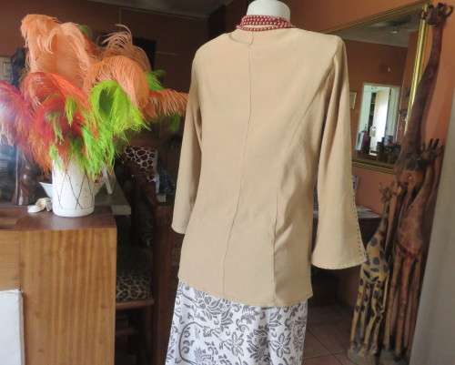 Ultra chic wheat shade slip over long sleeve top in suede look.Brown decor stitching.Size 36 by NEWS