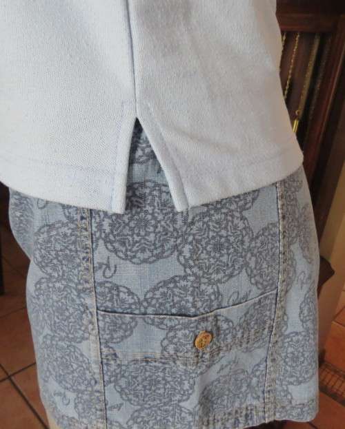 LACOSTE light blue top with white knitted collar and edging.Size 34 to 36.Opening in front.Good cond
