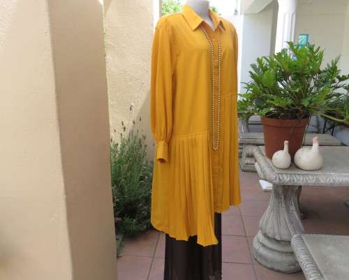 Uniquely styled long mustard top.Silky polyester.Button down.Right side longer.Size 38/40.As new