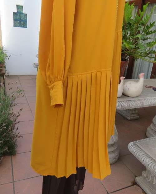 Uniquely styled long mustard top.Silky polyester.Button down.Right side longer.Size 38/40.As new