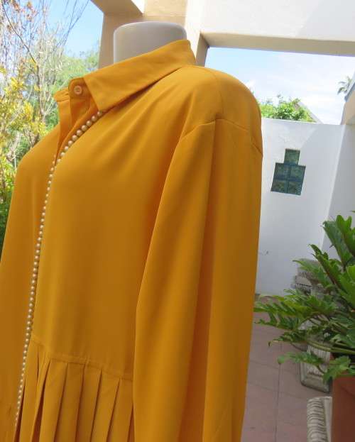 Uniquely styled long mustard top.Silky polyester.Button down.Right side longer.Size 38/40.As new