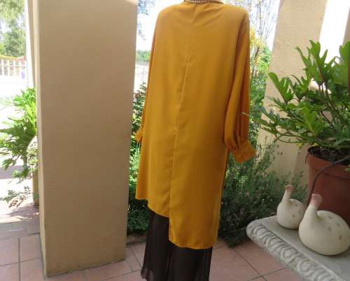 Uniquely styled long mustard top.Silky polyester.Button down.Right side longer.Size 38/40.As new