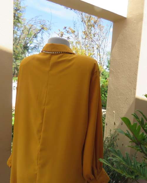 Uniquely styled long mustard top.Silky polyester.Button down.Right side longer.Size 38/40.As new