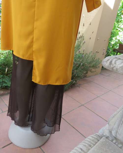 Uniquely styled long mustard top.Silky polyester.Button down.Right side longer.Size 38/40.As new