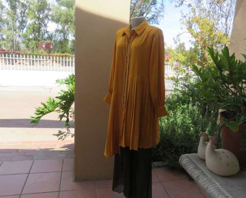 Uniquely styled long mustard top.Silky polyester.Button down.Right side longer.Size 38/40.As new