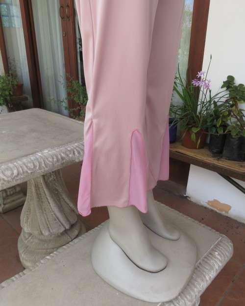 Dusty pink stretch polyester ankle length pants with sheer inlays at bottom. Size 36. Flat front.