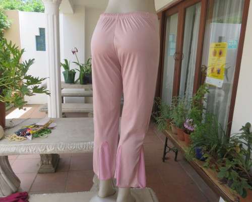 Dusty pink stretch polyester ankle length pants with sheer inlays at bottom. Size 36. Flat front.