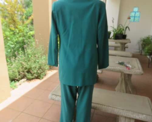 Elegant jade green 2 pc pantsuit by DAYTIMERS size 38/14. Long sleeve lined 3 button jacket.New cond
