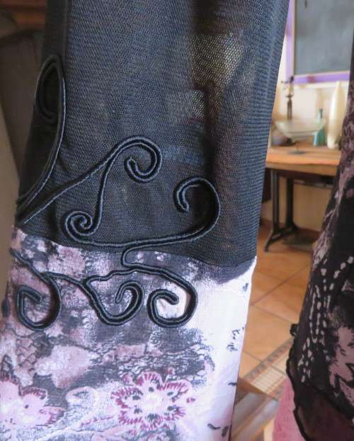 Stunning sheer black long sleeve top. Pale pink flowers on top layer.Size 34 by GOLD.Cord decoration
