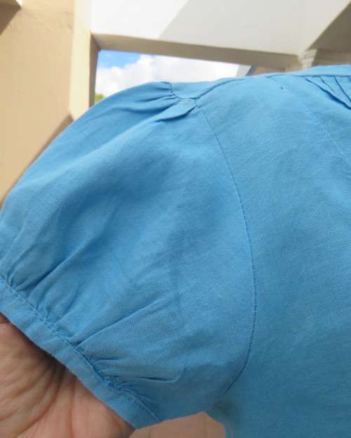 KELSO linen top with button down V front with collar in sky blue size 36/12.Tucked bib on front.