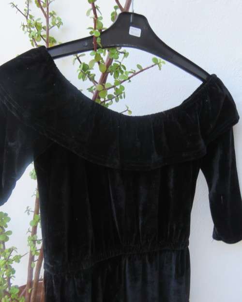 Black glamour stretch poly velvet jumpsuit calf length.Size 30/6.Scooped frilled neckline.As new.