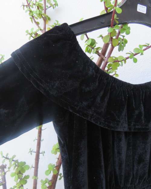 Black glamour stretch poly velvet jumpsuit calf length.Size 30/6.Scooped frilled neckline.As new.