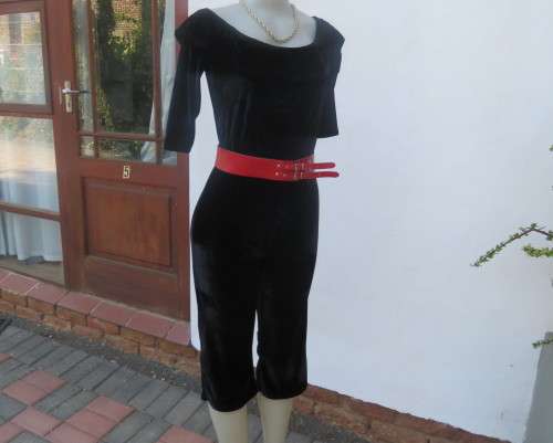 Black glamour stretch poly velvet jumpsuit calf length.Size 30/6.Scooped frilled neckline.As new.