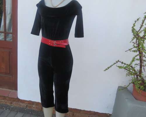 Black glamour stretch poly velvet jumpsuit calf length.Size 30/6.Scooped frilled neckline.As new.
