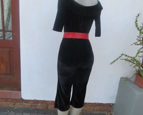 Black glamour stretch poly velvet jumpsuit calf length.Size 30/6.Scooped frilled neckline.As new.