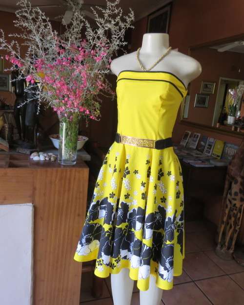 Fabulous buttercup yellow strapless dress with black/white floral flare skirt.Size 34/10 by LEGIT.