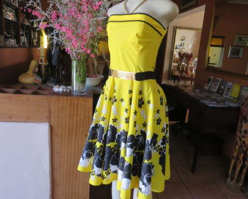 Fabulous buttercup yellow strapless dress with black/white floral flare skirt.Size 34/10 by LEGIT.