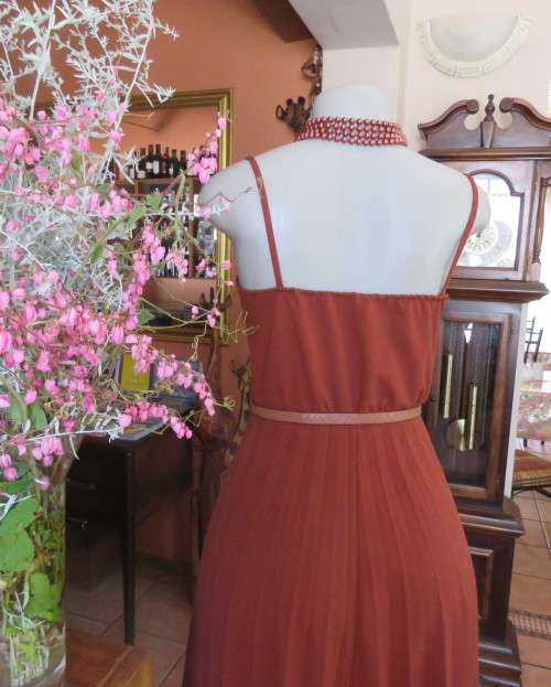 Sweet brick colour size 32 dress with permanent pleated bottom.Strappy top/lace decoration.As new